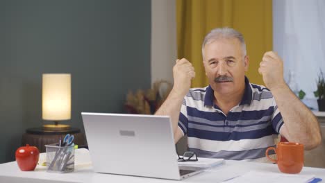 Home-office-worker-old-man-talking-motivationally-to-camera.